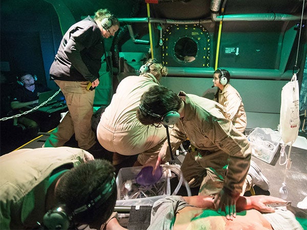 Students treating a patient in the MedEvac Simulation