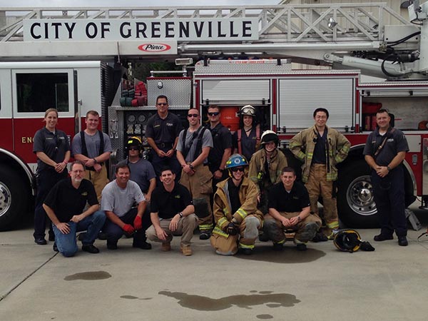 Students standing in front of a City of Greenville firetruck