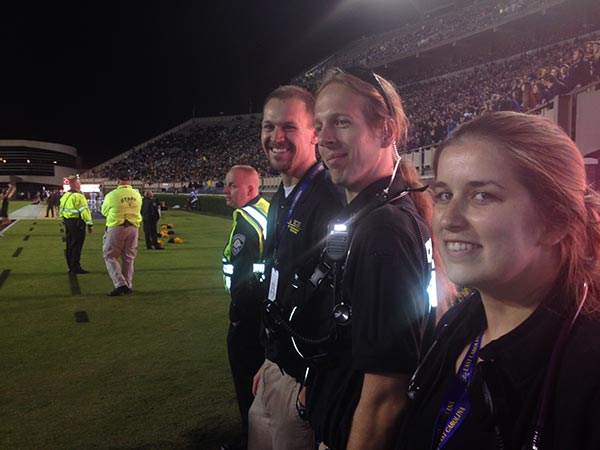 Students on the sidelines at an ECU football game